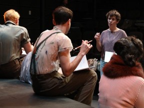 Director Sarah Kitz working with actors in costume on the set of Forever Young, which opens this week at the Great Canadian Theatre Company.