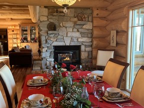 1.	In the dining room of Mattie and Hugh Montgomery’s log home. A crystal chandelier adds sparkle to a decorated table.