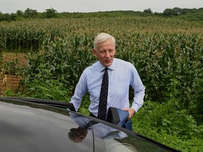Then-Canadian ambassador Dominic Barton gets into a car near the Dandong city detention centre after attending the guilty verdict hearing for Canadian businessman Michael Spavor on spying charges, Aug. 11, 2021.