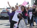CUPE members wave to passing traffic on Greenbank Road in Ottawa on Friday, Nov. 4.