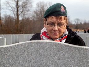 Laura Woolridge at her husband's grave in Beechwood Cemetery.