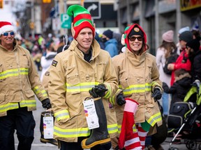 Firefighters made their way along the parade route on the 53rd year of operation, collecting toys, money and for the first time tap electronic donations.