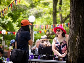 Melanie Ouellette, founder of the Ottawa Wildflower Seed Library, hands out small plants for free at an event earlier this year in Dundonald Park.