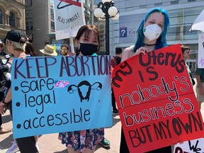 Two demonstrators join the pro-choice gathering on Parliament Hill May 12.