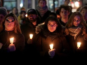 People attend a candlelight vigil at the Human Rights Monument in Ottawa after the recent Club Q shooting in Colorado Springs. Fae Johnstone, who argues (below) for the health care rights of trans people, notes 'Part of the problem ... is the stigma and misinformation surrounding care for transgender people.'