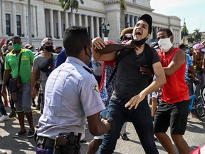 In this file photo taken on July 11, 2021, a man is arrested during a demonstration against the government of Cuban President Miguel Diaz-Canel in Havana.