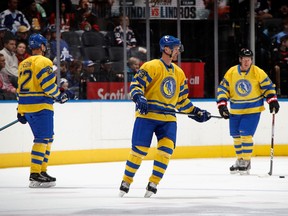 Left to right: Daniel Sedin, Daniel Alfredsson and Henrik Sedin skate in the Hockey Hall of Fame Legends Classic game at the Scotiabank Arena in Toronto, Nov. 13, 2022. The Hall induction ceremony will take place on Monday, Nov. 14.