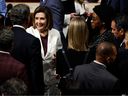 U.S. House Speaker Nancy Pelosi (D-CA) hugs lawmakers after delivering a speech from the Chambers of the U.S. Capitol on November 17.