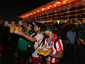 DOHA, QATAR - NOVEMBER 20: Fans drink beer during day 2 of the FIFA World Cup 2022 Qatar Fan Festival at Al Bidda Park on November 20, 2022 in Doha, Qatar.