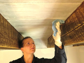 The key to a successful white wash finish comes down to consistently wiping in the direction of the wood grain. Here, whitewash is applied to pine planks that form a ceiling between rough-sawn beams.