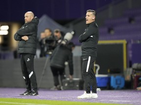 Canada's coach John Herdman, right, gives instructions to his players during the international friendly soccer match between Qatar and Canada, at the Viola Park stadium in Vienna, Austria, Friday, Sept. 23, 2022.