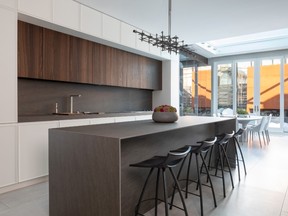 Large windows and glass doors help connect the kitchen to the outdoors.