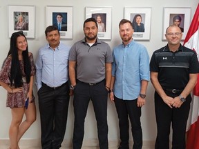A Canadian airline crew arrested and jailed after finding and reporting cocaine stashed on their plane in the Dominican Republic. From left, flight attendant Christina Carello, mechanic BK Dubey, First Officer Aatif Safdar, flight attendant Alexander Rozov and Capt. Rob DiVenanzo, at a recent citizenship ceremony for Dubey.