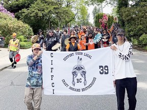 People take part in a march to draw attention to residential schools in Mission, B.C., June 4, 2022. Four participants in the march were allegedly struck on purpose by the driver of a truck.
