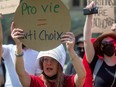 A protester dressed as a character from The Handmaid's Tale demonstrates on Parliament Hill during the National March for Life in Ottawa on May 12.