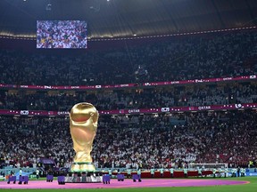 A photo shows the FIFA World Cup trophy replica ahead of the Qatar 2022 World Cup Group A football match between Qatar and Ecuador at the Al-Bayt Stadium in Al Khor, north of Doha on Nov. 20, 2022.