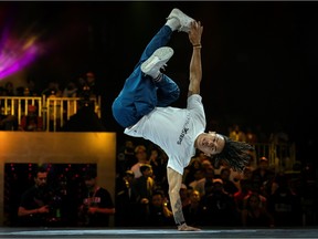 (FILES) In this file photo taken on November 9, 2019 Brazil's breakdancer Mateus de Sousa Melo aka Bart (white shirt) competes during the Red Bull BC One, the breakdance one-on-one battle world championship in Mumbai. - The International Olympic Committee (IOC) has chosen to integrate brakdancing into the 2024 Olympic Games in Paris.