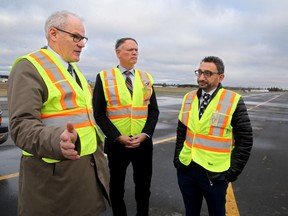 Minister of Transport Omar Alghabra (right), along with Ottawa South MP David McGuinty (centre) and Ottawa Airport CEO, Mark Laroche (left), were all on hand Monday at the Ottawa airport for the announcement of $4 million from the federal government to rehabilitate taxiways.