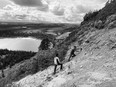 Canadian astronaut Joshua Kutryk and NASA astronaut Matthew Dominick hike up Discovery Hill on the Mistastin Crater.