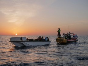 Migrants wait to be rescued by crew members of NGO rescue ship 'Ocean Viking' in the Mediterranean Sea, October 26, 2022.