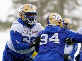 Winnipeg Blue Bombers offensive lineman Stanley Bryant (66) and defensive end Jackson Jeffcoat (94) battle for position during Grey Cup team practice in Regina, Friday, Nov. 18, 2022.&ampnbsp;Winner of the CFL's most outstanding offensive lineman award this season for a record fourth time, Bryant will have a hand in protecting Blue Bombers quarterback Zach Collaros in Sunday's Grey Cup game against the Toronto Argonauts.