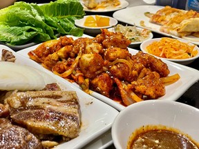 From left to right, short ribs to be cooked on a tabletop grill, sweet and spicy fried chicken and assorted side dishes at Korean House restaurant in Ottawa’s Chinatown.