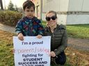 Audrey Neal (right) and her son Matthew, 4, supported striking CUPE education workers in Kanata on Friday. Neil said his son Zach, 6, has autism and that teaching assistants are making a difference in his classroom. 