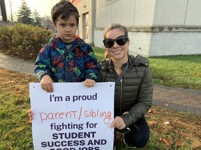 Audrey Neale, right, with son Matthew, 4, supported striking CUPE education workers in Kanata on Friday. Neale said her son Zack, 6, has autism and education assistants make a difference in his classroom.