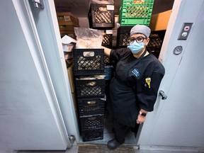 Ottawa Mission sous chef Silvia Henriquez stands in the facility's freezer, which is filled with containers of cooked turkey for this years Christmas dinner which will feed upwards of 15,000 people.