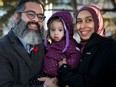Zahid Bashir and his wife Sobia Qureshi try to keep their one-year-old daughter, Ayla Bashir, warm while having their picture taken outside CHEO Wednesday.