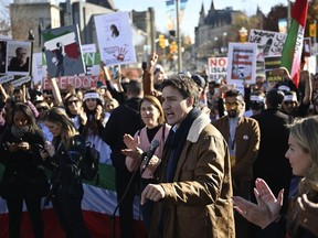 Prime Minister Justin Trudeau speaks to demonstrators in Ottawa on Saturday, Oct. 29, 2022. Demonstrators in several major Canadian cities Saturday took part in a worldwide "human chain" organized by the Association of Families of Flight PS752.