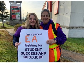 Education assistants Jocelyn Bond, left, and Tina Cannon were among the CUPE education workers in the picket lines in Kanata Friday morning. Joanne Laucius/Postmedia