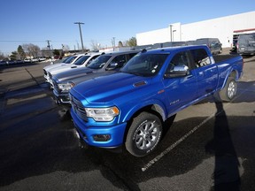 File - 2022 Ram pickup trucks are displayed at a Dodge dealership on Sunday, Feb. 27, 2022, in Littleton, Colo. Gas-electric hybrids were the most reliable vehicles sold in the U.S. in the past year, while pickup trucks and battery-electric automobiles performed the worst in Consumer Reports' annual survey.