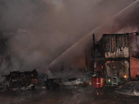 Petugas pemadam kebakaran mengatasi bahaya termasuk tangki diesel yang terbakar di toko komersial