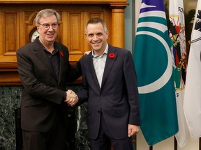 Mayor Jim Watson welcomes Mayor-elect Mark Sutcliffe to his office for a transition briefing at city hall recently. Sutcliffe was sworn in as the new mayor Tuesday.