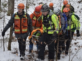 Members of Ottawa Volunteer Search and Rescue evacuate an "injured" hiker during a training exercise near Low, Que., on Nov. 19, 2022.