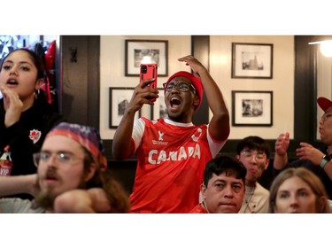 Djamal Mbae reacts as he watches the Canada-Belgium game at the Glebe Central Pub Wednesday afternoon.