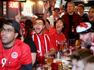 From left, Eddie Benin, Jessie Porter, Josh Geauvreau and Vahid Seddigh cheer while Bryce Crossman (far right) looks nervous. 
Canadian soccer fans were going crazy at the Glebe Central Pub Wednesday afternoon as Canada played Belgium in the World Cup.