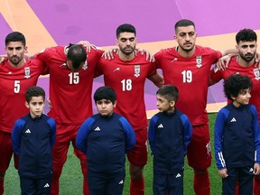 Iran's soccer team lines up during the national anthems before the Nov. 21 match.