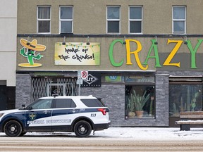 A file photo shows a Saskatoon police vehicle parked outside Crazy Cactus Bar on November 7, two days after Hodan Hashi, 23, was stabbed to death there.