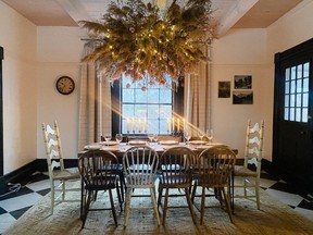 Dramatic dried florals float above the Christmas table inside Kate Crothers Little’s table, in Bath, On. She wove the piece together using using foraged grapevines, pampas grass and asters.
