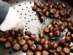 FILE: Luciano Pradal roasts his chestnuts at ByWard Market in Ottawa, December 23, 2010.
