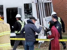Dr. Linna Li, front right, acting medical officer of health at the Leeds, Grenville and Lanark District Health Unit, speaks to a para transit company official and a police officer at the scene of a para transit bus collision on Friday afternoon. (RONALD ZAJAC/The Recorder and Times)
