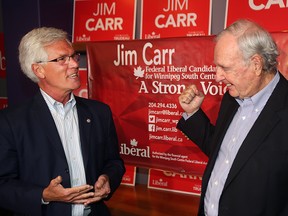 Jim Carr (left), then the Liberal candidate for Winnipeg South Centre, shares a moment with former prime minister Paul Martin at his campaign office in Winnipeg in 2015.