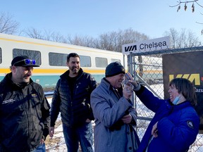 Chelsea Cadieux, right, flashes her trademark playing cards with Mike Oliphant while fellow Via Rail engineers Tyson Venne and Dominique Marleau look on.