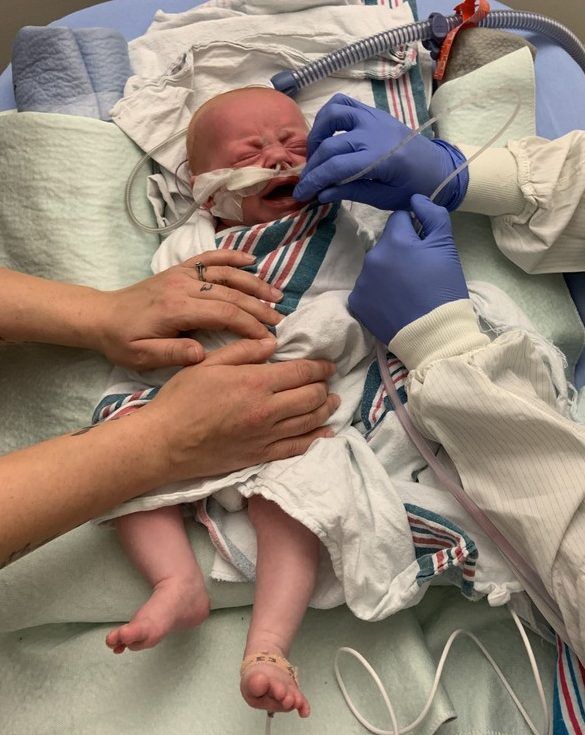 priscilla cloutier, left, comforts her 11-week-old daughter, hailey o’grady, while cheo respiratory therapist jill kimber suctions hailey’s lungs. hailey and her twin brother, hunter, have rsv.