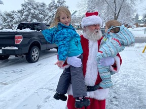 Melody Hoskins, left, and Wyatt Hoskins were recently greeted by Santa, who had driven by them on their street, then came back to wish them a Merry Christmas.