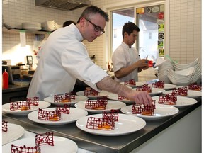 Marc Lepine, award-winning chef and owner of Atelier, is seen plating one of the courses served to dinner guests at a fundraiser at his restaurant in 2016 to raise money for the Thirteen Strings Chamber Orchestra.