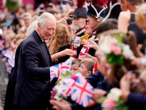 Crowds cheer as King Charles III and Camilla, Queen Consort, arrive for a visit to Hillsborough Castle in Northern Ireland, on Sept. 13.
