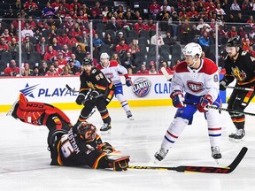 Jacob Markstrom of the Calgary Flames leaves his net to stop a shot from Sean Monahan of the Montreal Canadiens during the first period at Scotiabank Saddledome in Calgary on Dec. 1, 2022.
